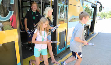 A group of children boarding a bus.