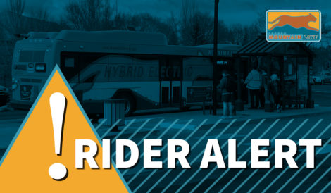 A rider alert sign is shown in front of a bus.